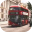 Red double-decker bus driving down a street