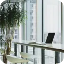 Laptop on a table in front of a window