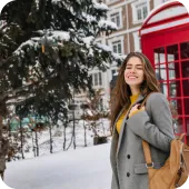 Woman standing by a red telephone booth