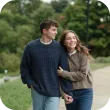 Young couple holding hands while walking in a park