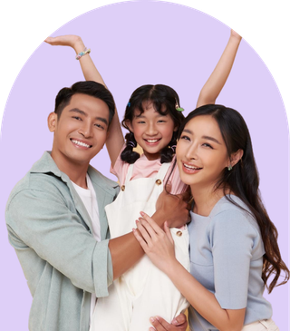 A happy family portrait featuring a man, woman, and a child smiling together outdoors.