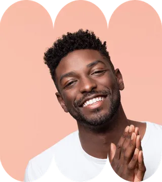A man with a beard wearing a white shirt, smiling and looking directly at the camera.