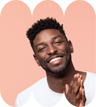 A man with a beard wearing a white shirt, smiling and looking directly at the camera.