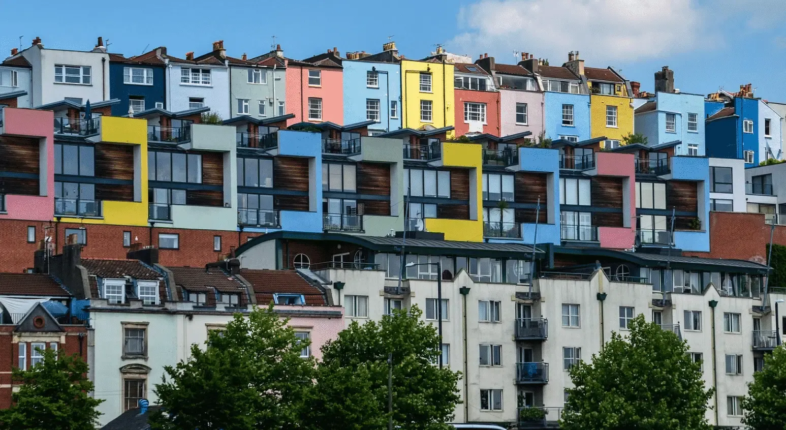 treet view of vibrant, multicolored houses on a hillside in the UK