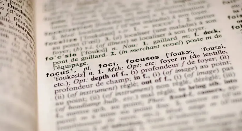 Close-up of a dictionary page highlighting the definition of the word 'focus