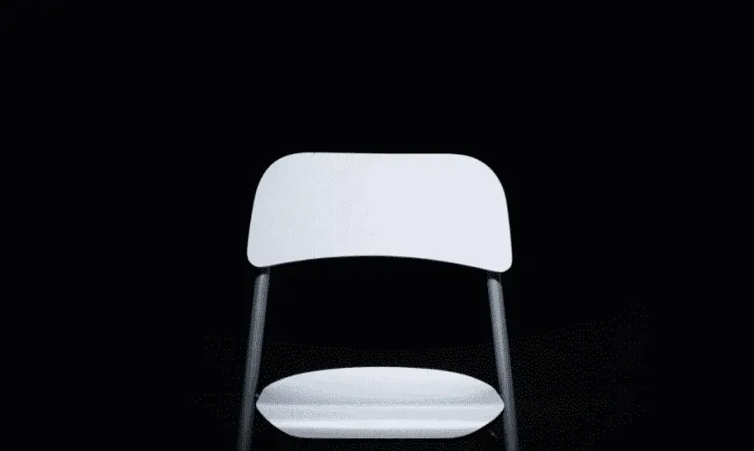 Minimalist image of a white chair against a solid black background
