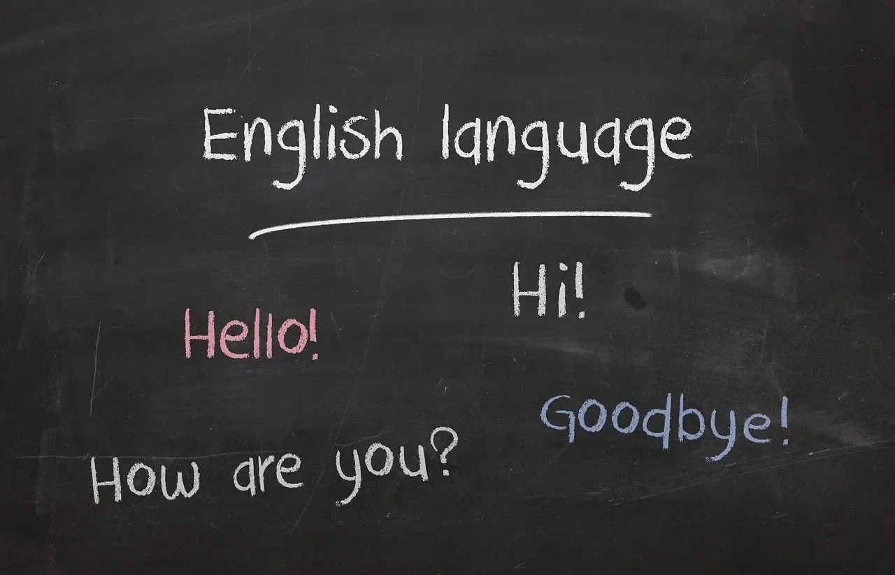 Chalkboard with basic English words and phrases like "Hello," "Hi," "How are you?" and "Goodbye," used for language learning