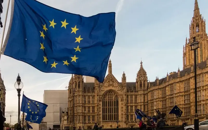 European Union flag flying near the Palace of Westminster in London, representing EU nationals' presence and rights in the UK