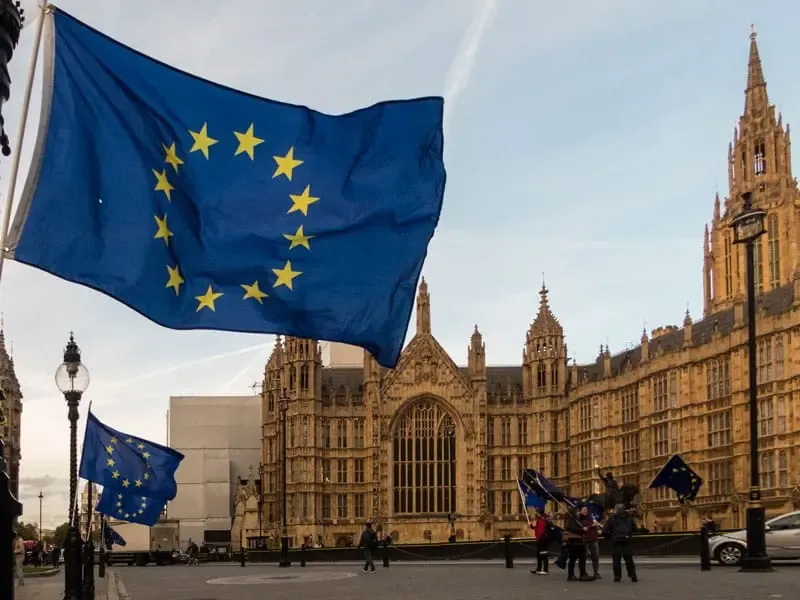 European Union flag flying near the Palace of Westminster in London, representing EU nationals' presence and rights in the UK