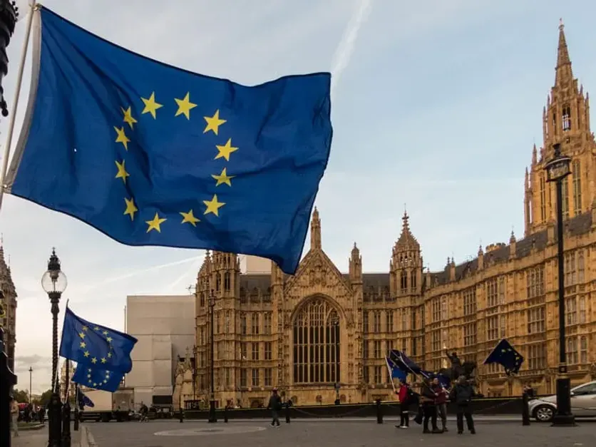 European Union flag flying near the Palace of Westminster in London, representing EU nationals' presence and rights in the UK
