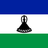 Flag of Lesotho with blue, white, and green horizontal stripes and a black Basotho hat in the center