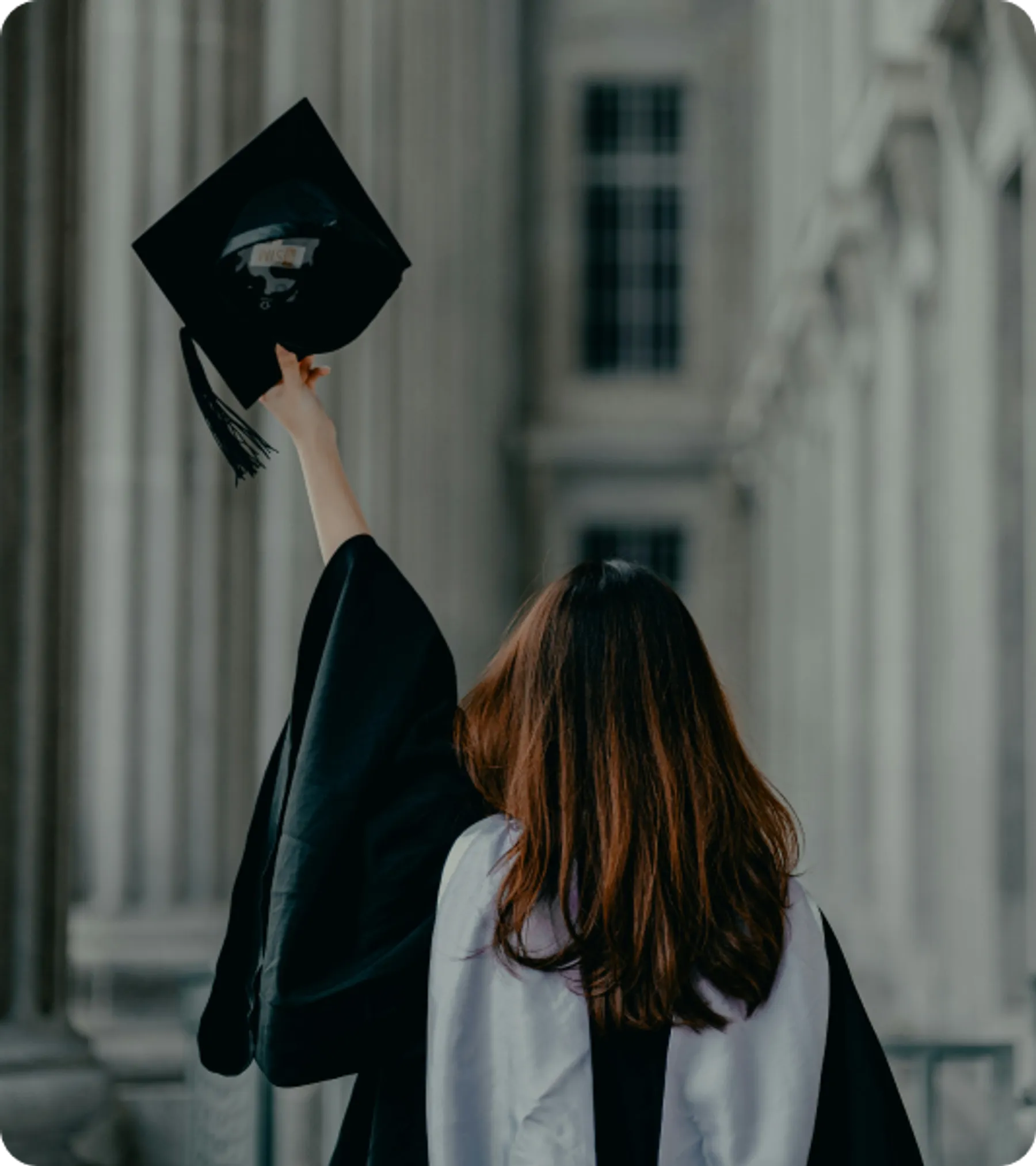 University graduate raising cap in celebration, representing eligibility for the UK High Potential Individual Visa scheme