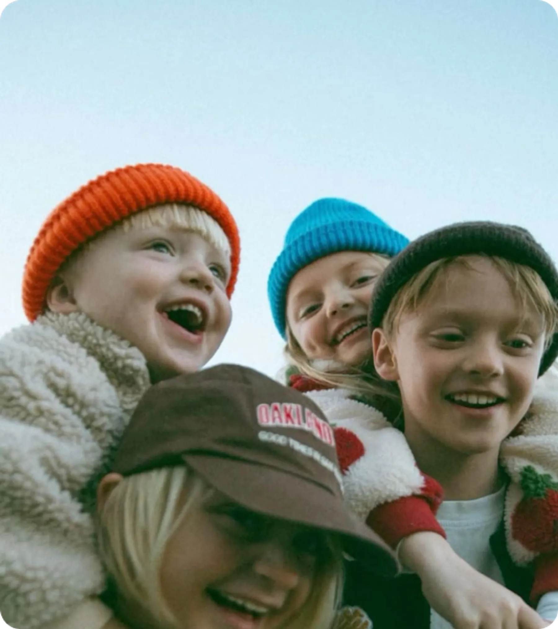 Group of smiling children wearing colorful hats, symbolizing family unity for UK child dependent visa representation