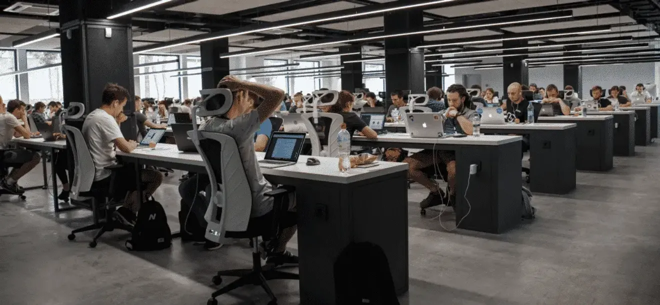 Modern open-plan office with employees working at computer desks
