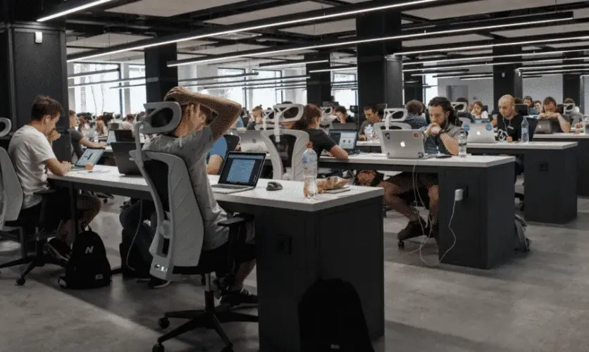 Modern open-plan office with employees working at computer desks