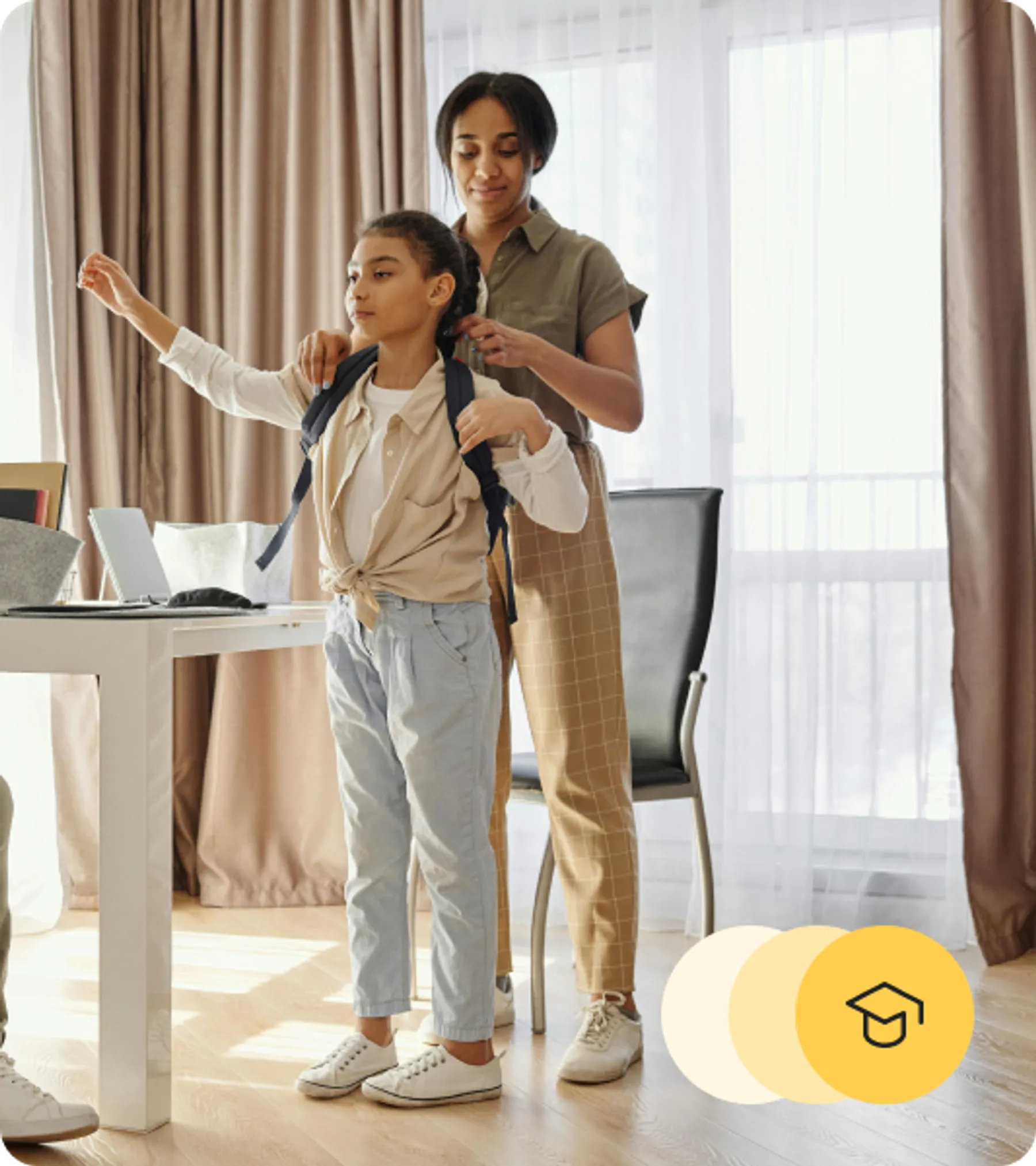 Mother helping her young daughter put on a backpack in a warmly lit home.