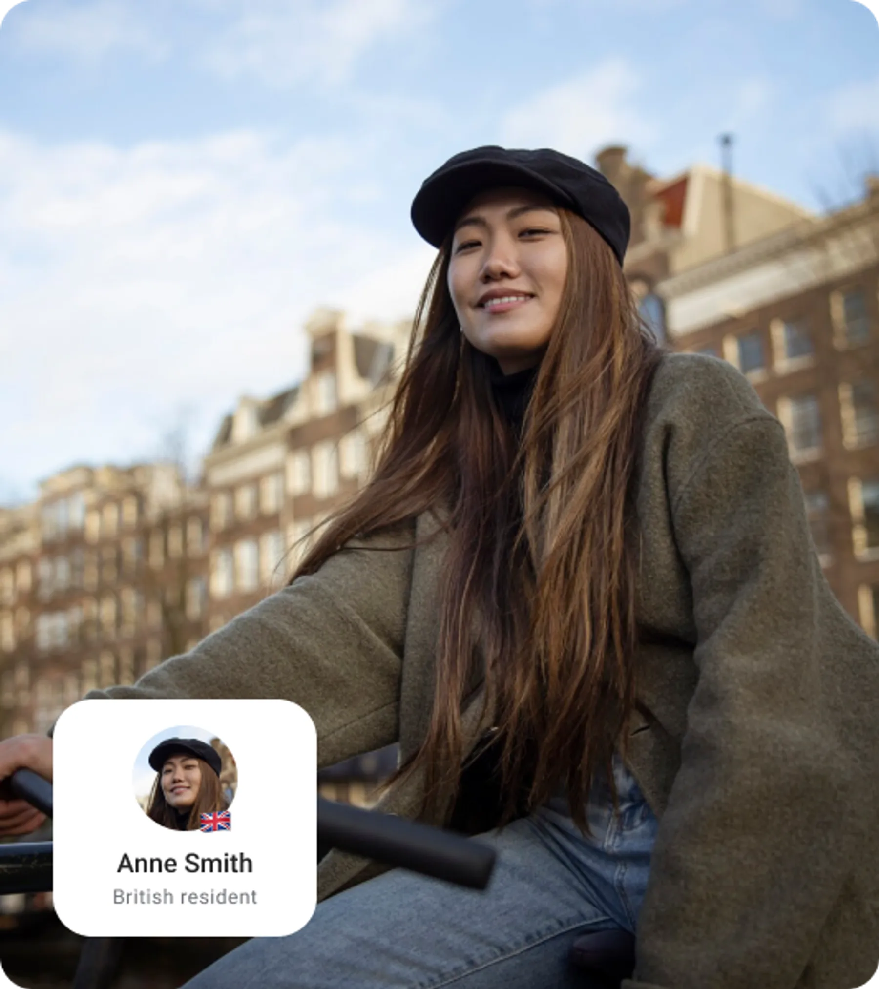 Smiling woman with long hair and a cap riding a bicycle through a European-style city with overlay image representing they are a British resident.