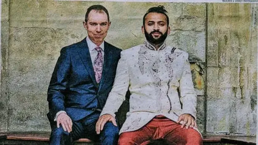 Portrait of a same-sex couple in formal attire, representing partnership-based immigration rights in the UK