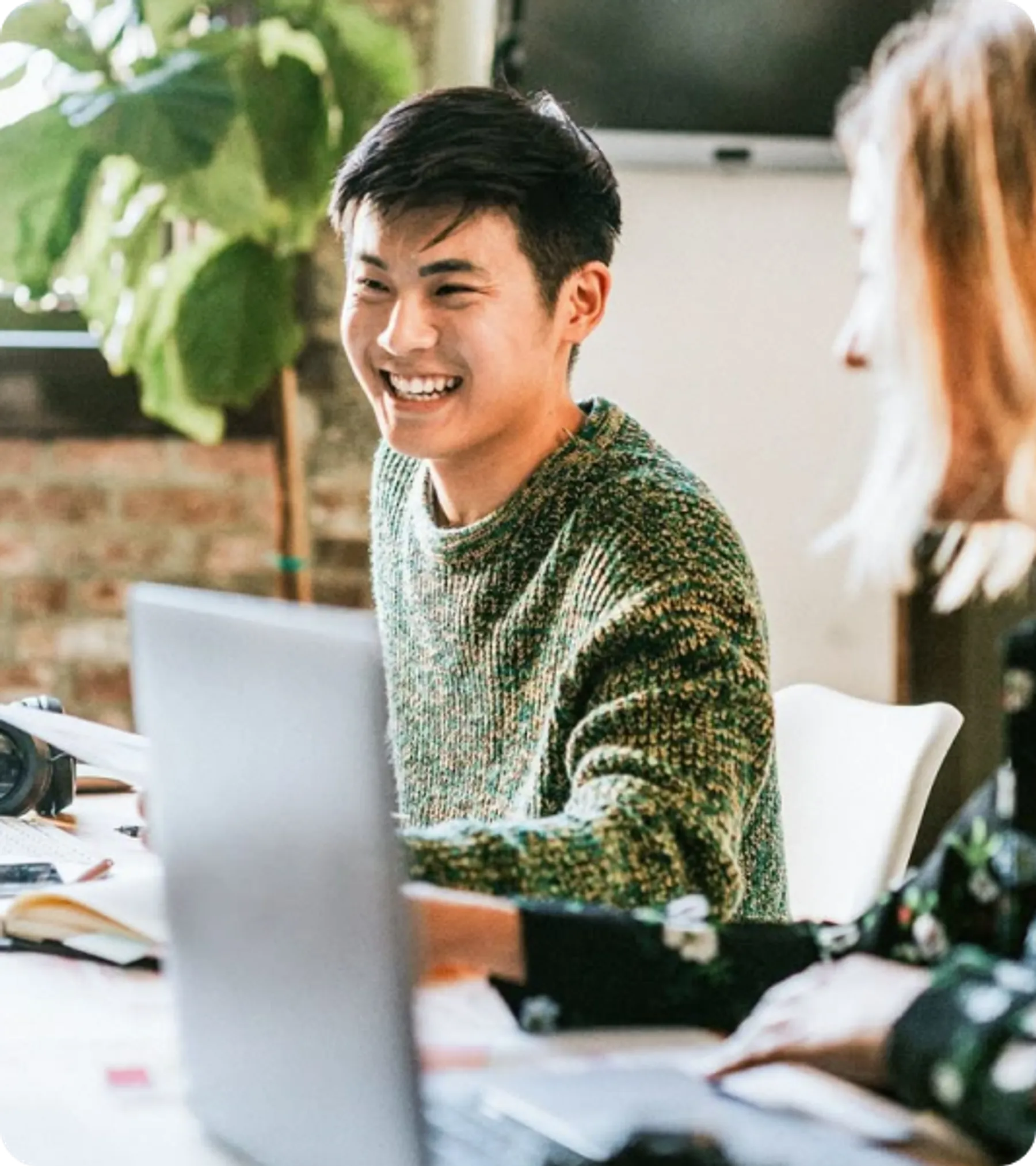 Smiling professionals in a casual business meeting, representing applicants for the UK Business Visit Visa
