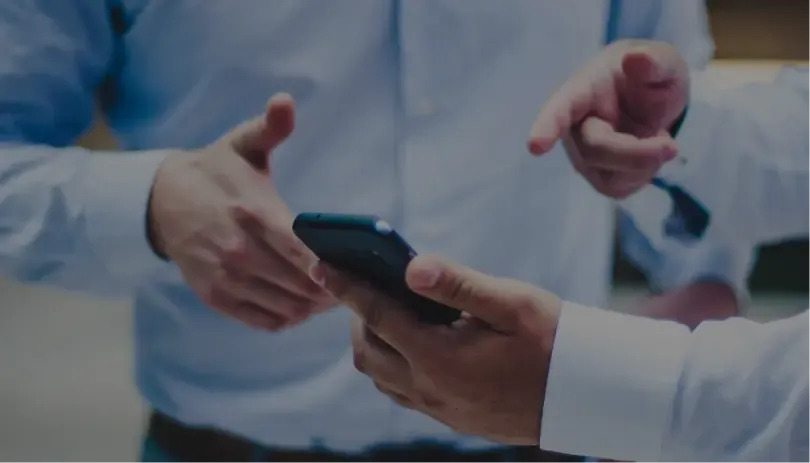 ands exchanging a smartphone, indicating employment termination communication