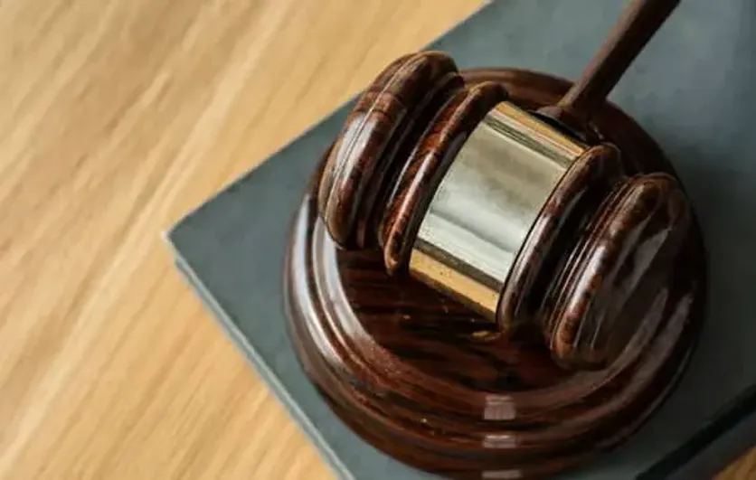 Wooden gavel resting on a block atop a desk, symbolizing legal proceedings in UK immigration courts