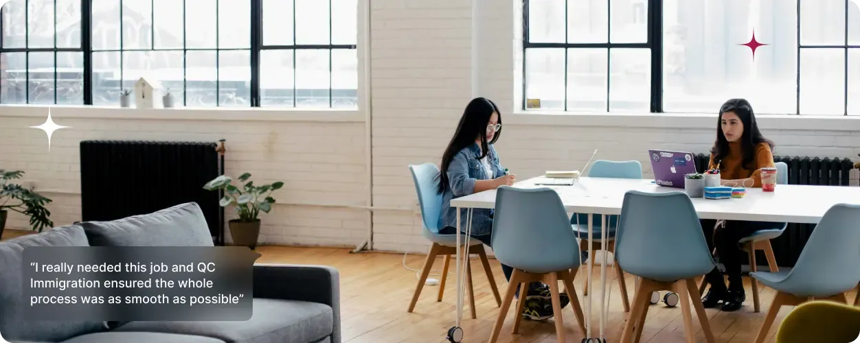 Two women working at laptops in a bright modern office, representing professionals eligible for UK short-term work visa options