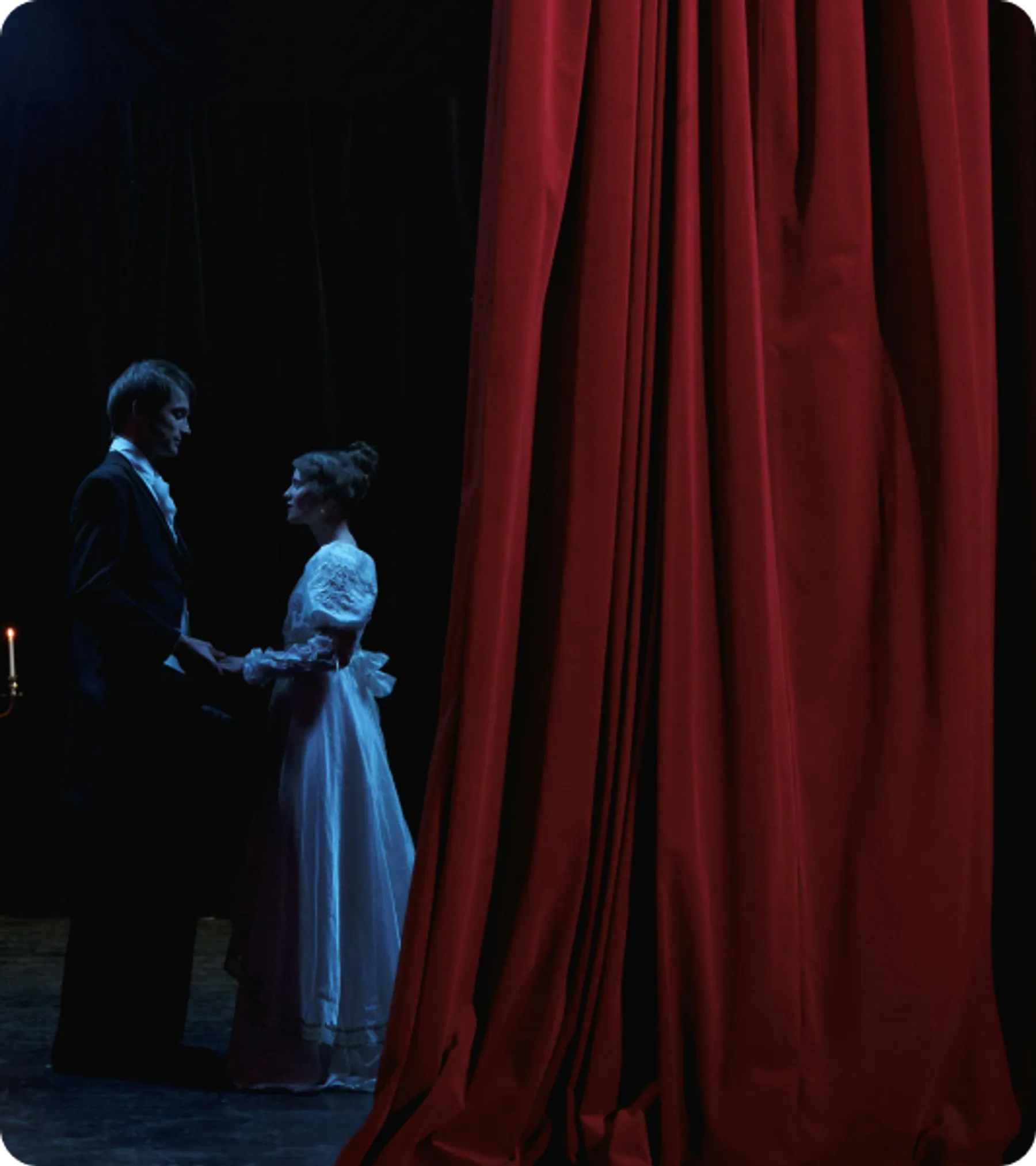 Stage actors in period costume performing behind red curtain, representing applicants for the UK Temporary Work – Creative Worker Visa