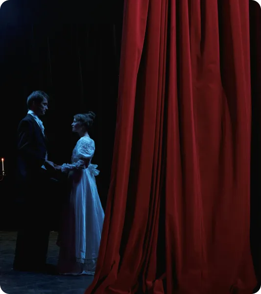 Stage actors in period costume performing behind red curtain, representing applicants for the UK Temporary Work – Creative Worker Visa