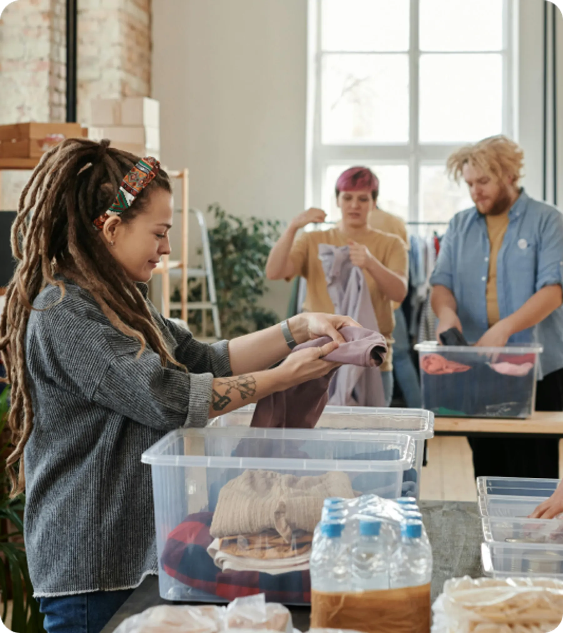 Group of people sorting clothes in a volunteer setting representing temporary worker visa applicants in the UK