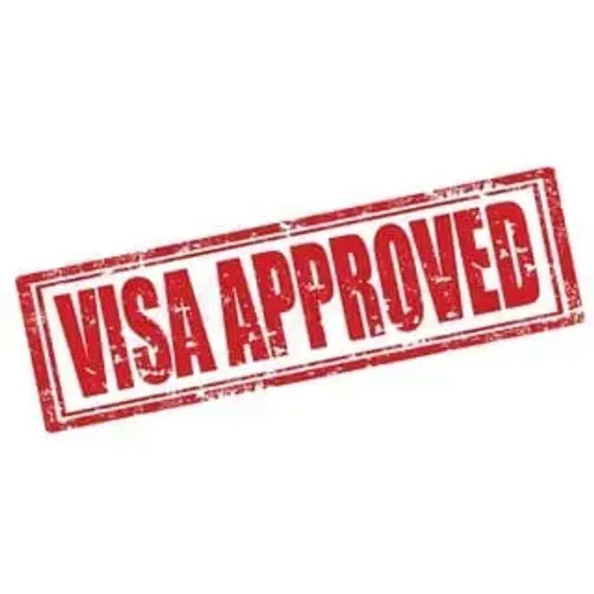 Red stamp with the words 'Visa Approved' on a white background
