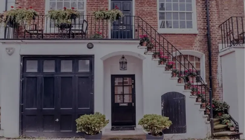 A welcoming home with a staircase and flowers, illustrating the idea of stability and security in a spouse visa relationship